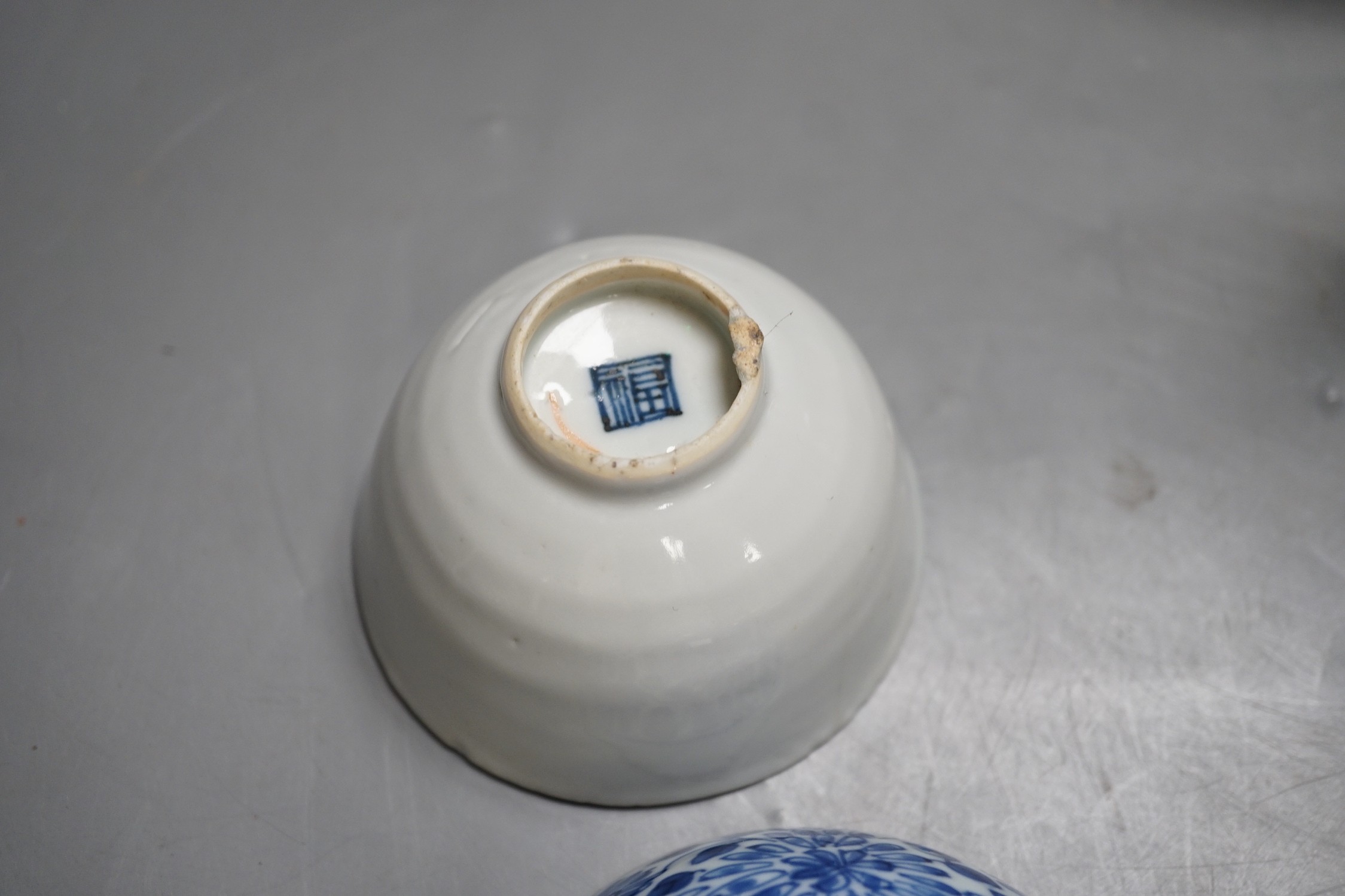 A Chinese Ming dynasty internally decorated porcelain tea bowl, an 18th century blue and white bowl, two other blue and white bowls, a similar water pot and an Islamic brass vessel